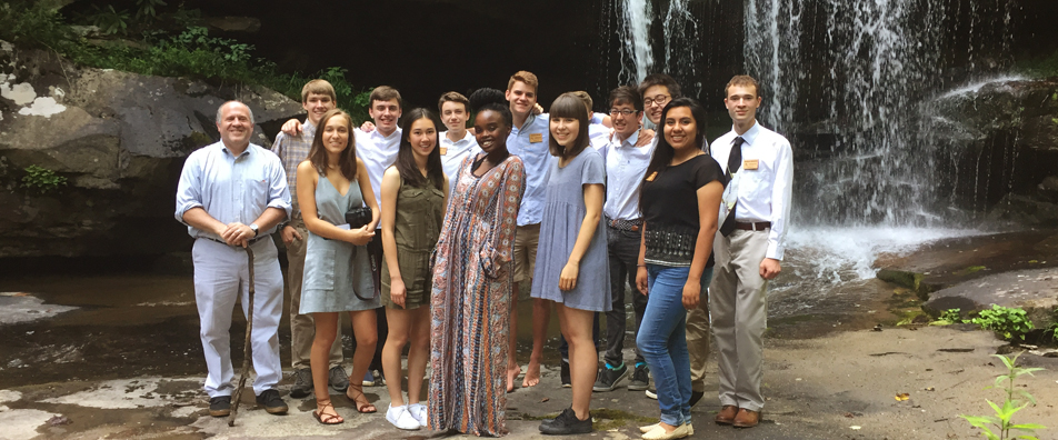 Students pose near the waterfall at Bear Run. Students pose near the waterfall at Bear Run.