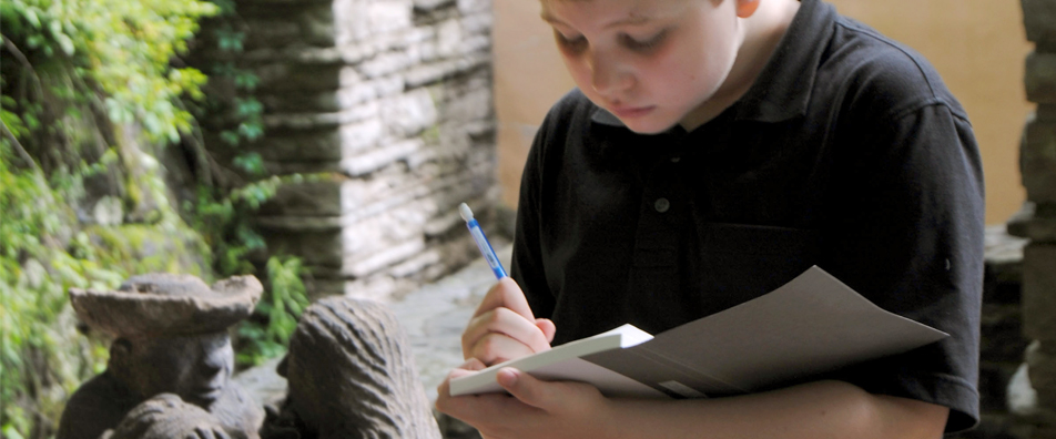 A student on a Fallingwater terrace taking notes. A student on a Fallingwater terrace taking notes.