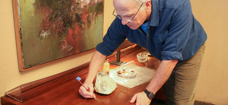 Wood conservation efforts, such as touching up finishes on the black walnut veneer of the guest house desk, occur each winter. Wood conservation efforts, such as touching up finishes on the black walnut veneer of the guest house desk, occur each winter.